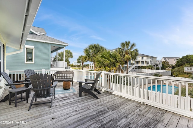 deck featuring a fenced in pool