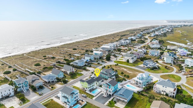 aerial view with a water view and a beach view