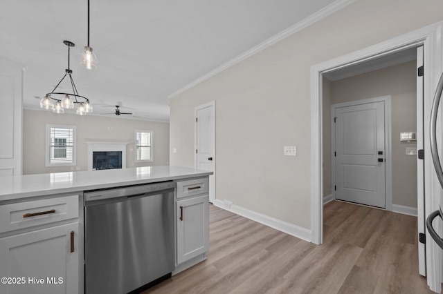 kitchen featuring stainless steel dishwasher, ceiling fan, crown molding, pendant lighting, and white cabinets