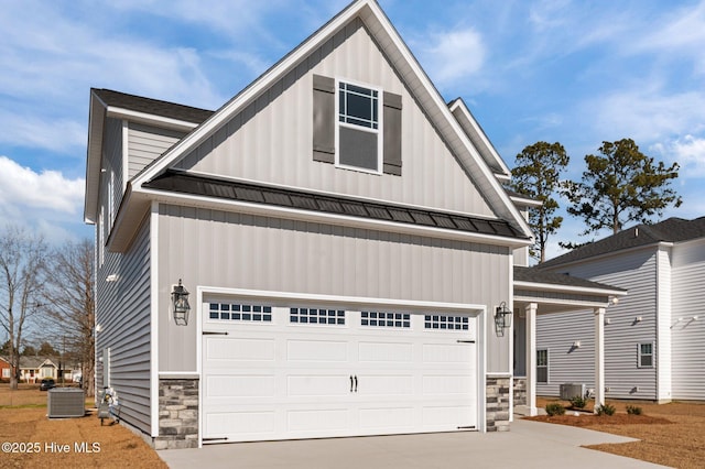 view of front facade featuring a garage and central air condition unit