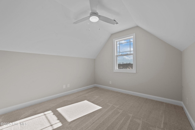 additional living space with ceiling fan, light carpet, and vaulted ceiling