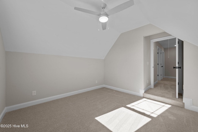 bonus room with ceiling fan, light colored carpet, and lofted ceiling