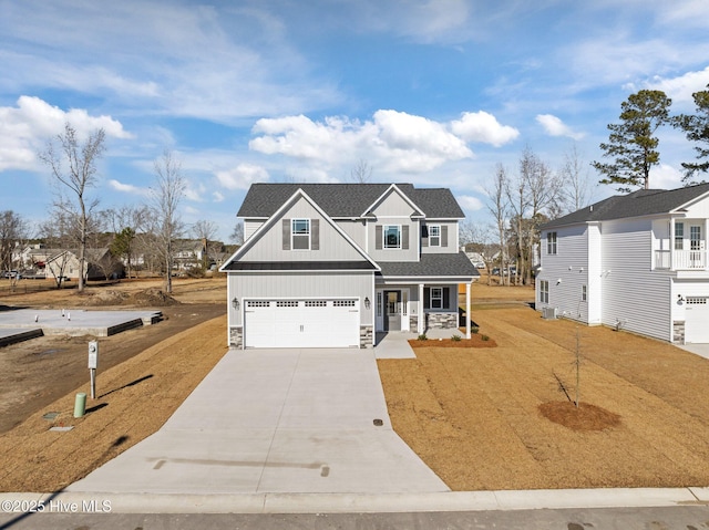 view of front of house featuring a porch and a garage