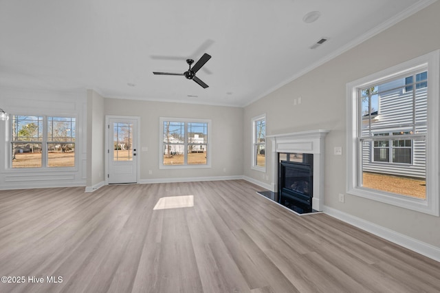 unfurnished living room with light wood-type flooring, ceiling fan, and ornamental molding