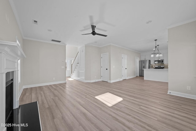 unfurnished living room featuring light wood-type flooring, ceiling fan, and ornamental molding