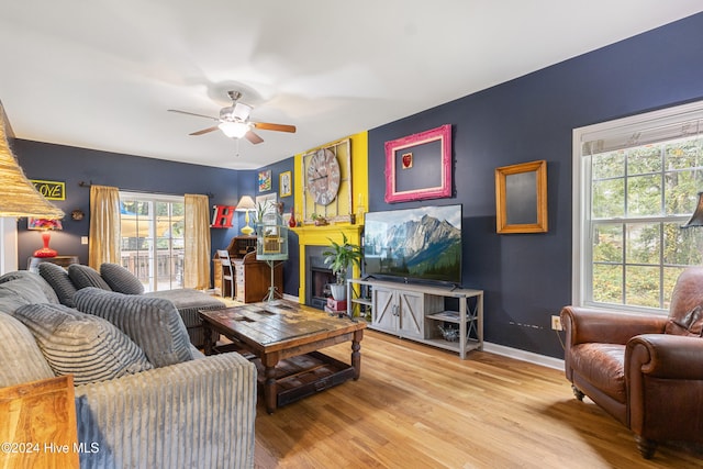 living room featuring light wood-type flooring and ceiling fan