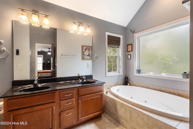 bathroom with tiled bath, vanity, tile patterned floors, and lofted ceiling