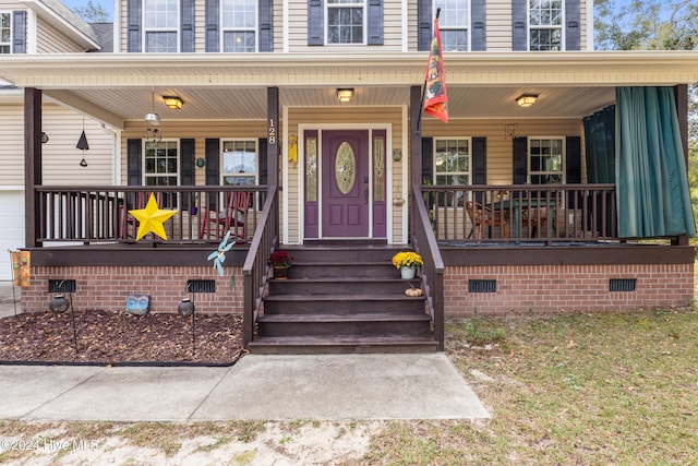 view of exterior entry featuring a porch