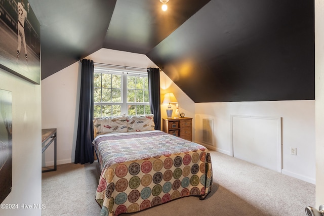 carpeted bedroom featuring vaulted ceiling