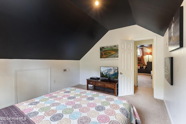 bedroom featuring light carpet and vaulted ceiling