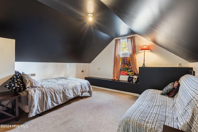 carpeted bedroom with lofted ceiling