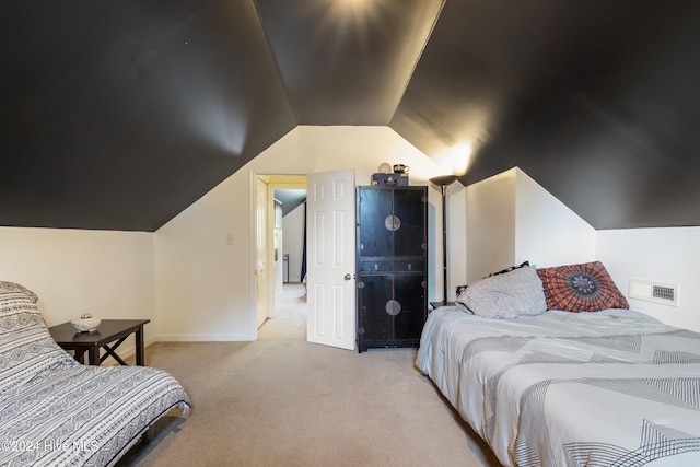 carpeted bedroom featuring vaulted ceiling