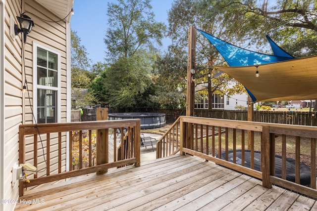 deck featuring a covered pool