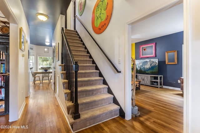 stairs with hardwood / wood-style flooring