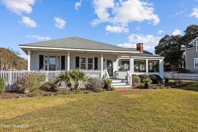 view of front of property with a front yard and covered porch