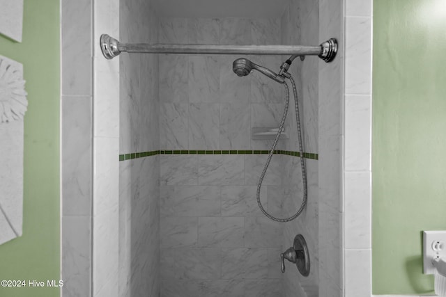 bathroom with tiled shower