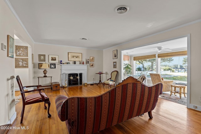 living room with wood-type flooring and crown molding