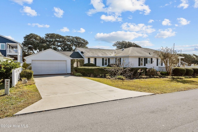 single story home with a front lawn and an outdoor structure