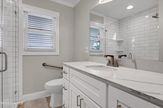 bathroom featuring tile patterned flooring, vanity, toilet, and a shower with shower door