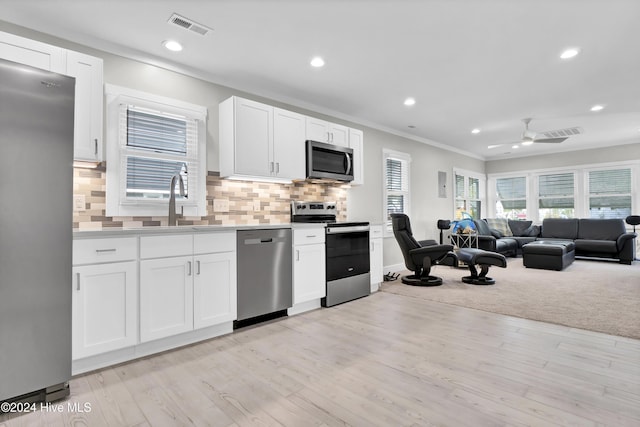 kitchen featuring light wood-type flooring, white cabinetry, and appliances with stainless steel finishes