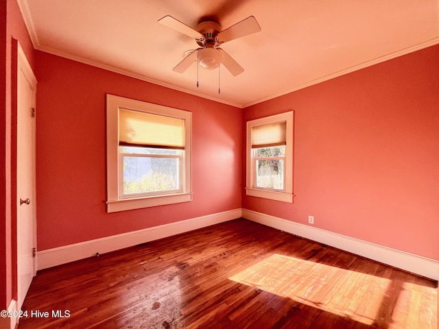 spare room featuring wood-type flooring, ceiling fan, and ornamental molding