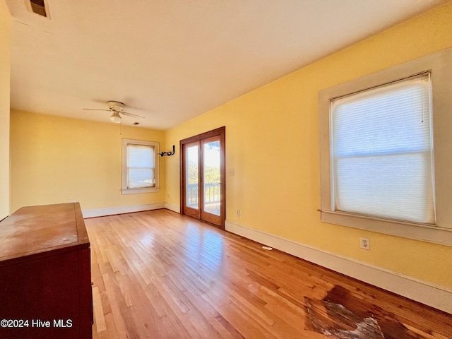 spare room featuring light wood-type flooring and ceiling fan