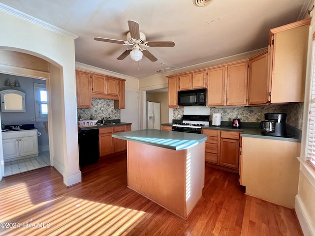 kitchen featuring a center island, backsplash, black appliances, light hardwood / wood-style flooring, and ceiling fan