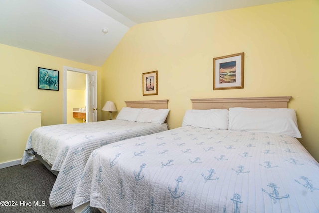 bedroom with carpet, vaulted ceiling, and ensuite bath