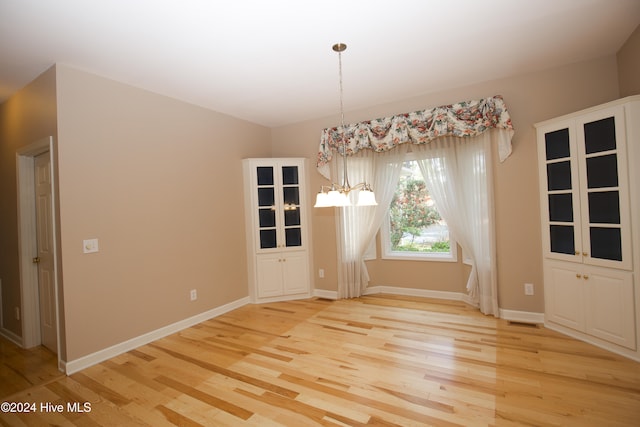 unfurnished dining area with light wood-type flooring