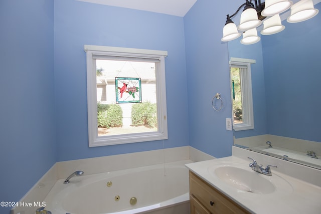 bathroom with a notable chandelier, vanity, and a wealth of natural light