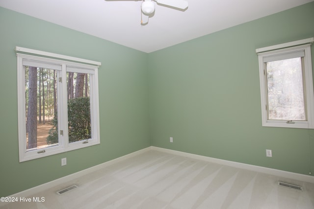 empty room featuring carpet flooring and ceiling fan