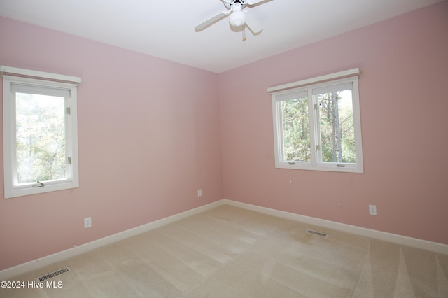 carpeted empty room featuring ceiling fan