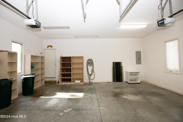 garage with electric panel and a garage door opener