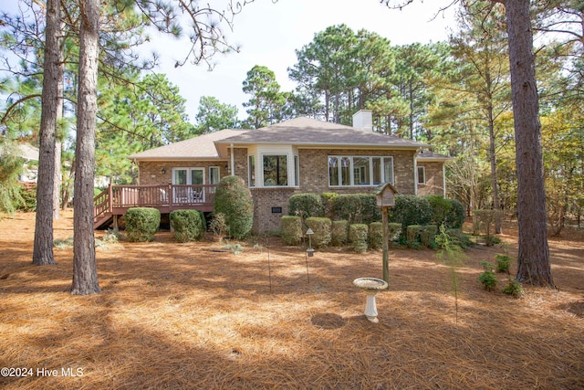 view of front facade with a wooden deck