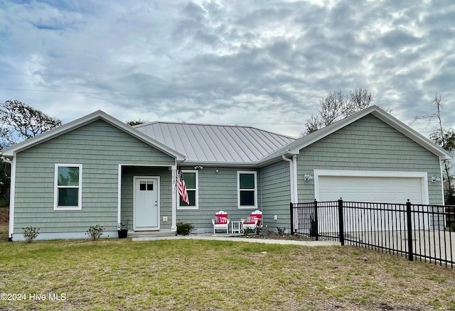 view of front of home with a front yard and a garage