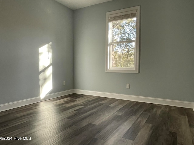 unfurnished room featuring dark hardwood / wood-style floors