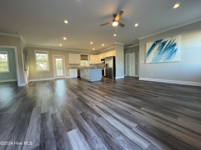 unfurnished living room with dark hardwood / wood-style floors, ceiling fan, and crown molding