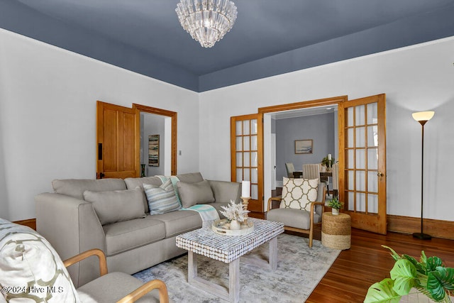 living room featuring a chandelier, hardwood / wood-style floors, and french doors