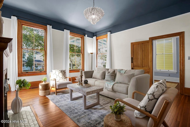 living room featuring hardwood / wood-style flooring and a chandelier