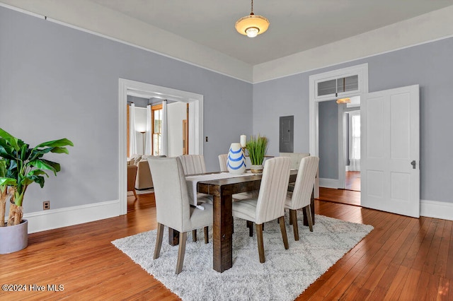 dining room featuring electric panel and hardwood / wood-style flooring