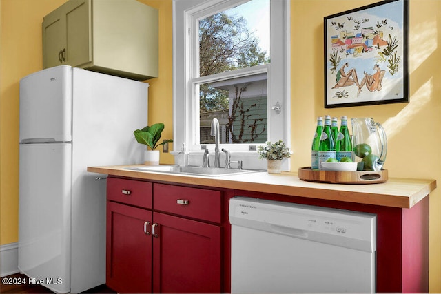 kitchen featuring white appliances and sink