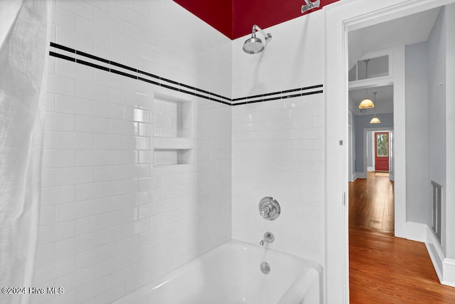 bathroom featuring hardwood / wood-style floors and shower / bath combo