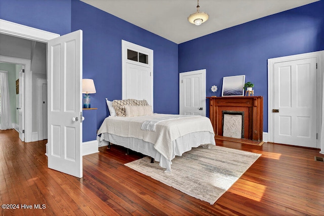 bedroom with dark hardwood / wood-style floors