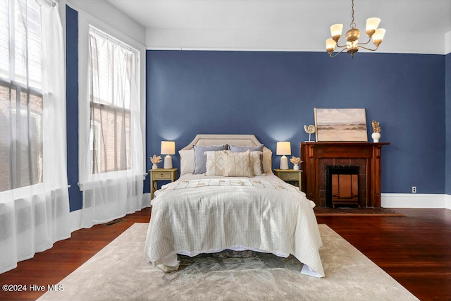 bedroom featuring a notable chandelier and dark hardwood / wood-style floors