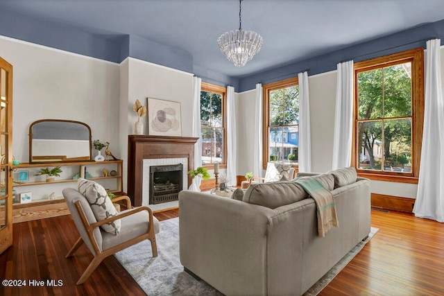 living room with a chandelier and light wood-type flooring