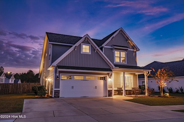 view of front of home featuring a garage and a yard