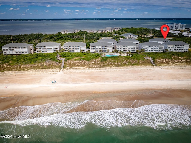 bird's eye view with a water view and a beach view