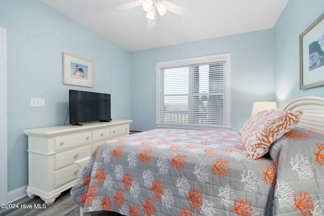 bedroom with hardwood / wood-style floors and ceiling fan