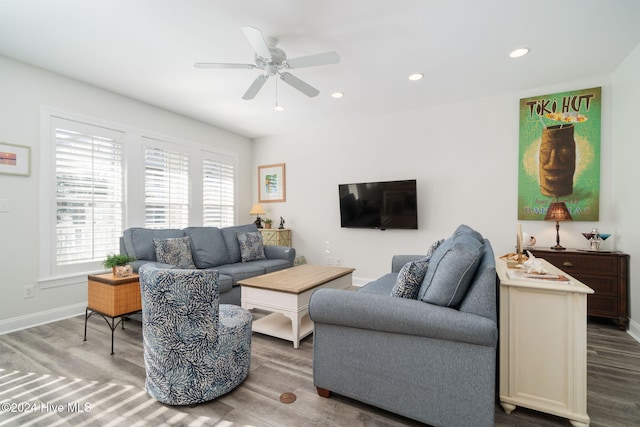 living room featuring hardwood / wood-style floors and ceiling fan