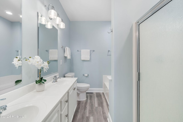 full bathroom featuring hardwood / wood-style flooring, shower with separate bathtub, vanity, and toilet